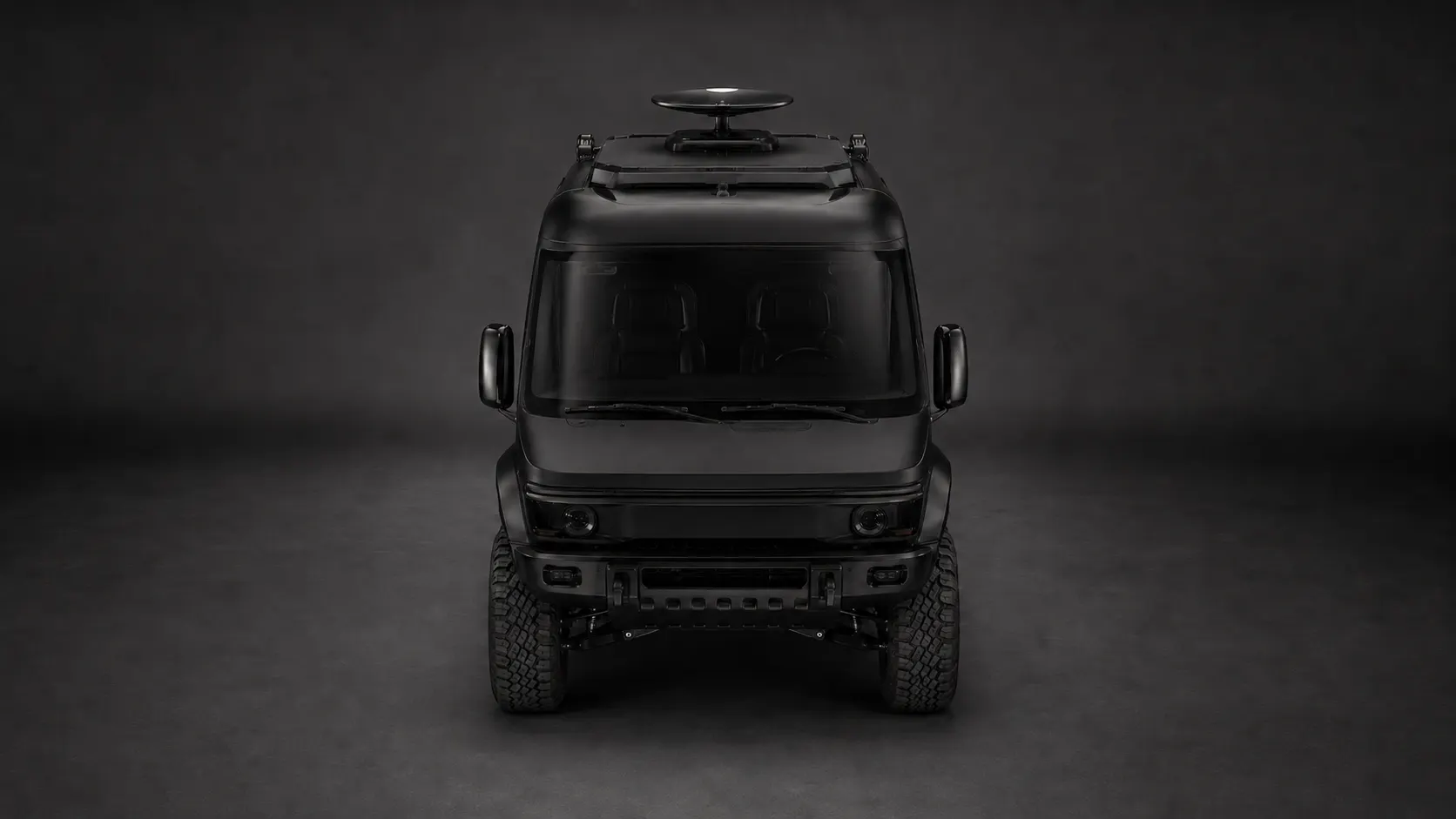 Studio front view of the WERX-Mobile concept: a matte-black high-clearance 4x4 with a roof rack and satellite dome, lit against a dark backdrop.