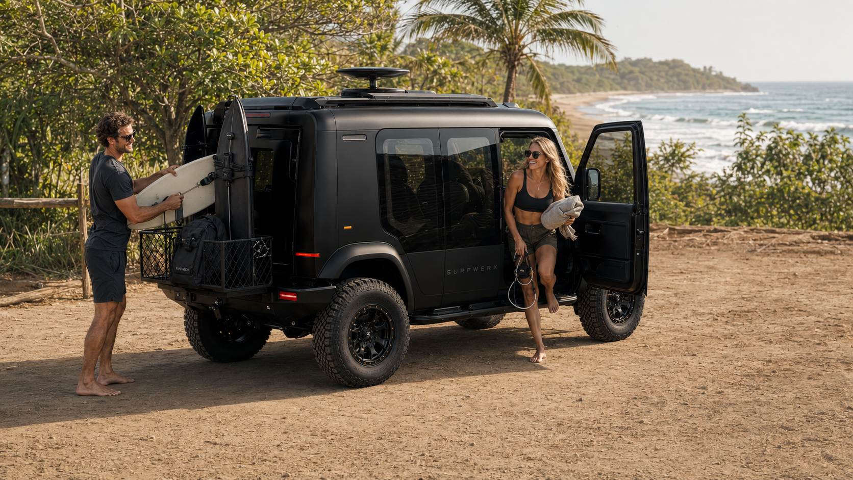 Two surfers unloading boards and gear from the WERX-Mobile on a sand track above the beach, ocean and palms behind them.
