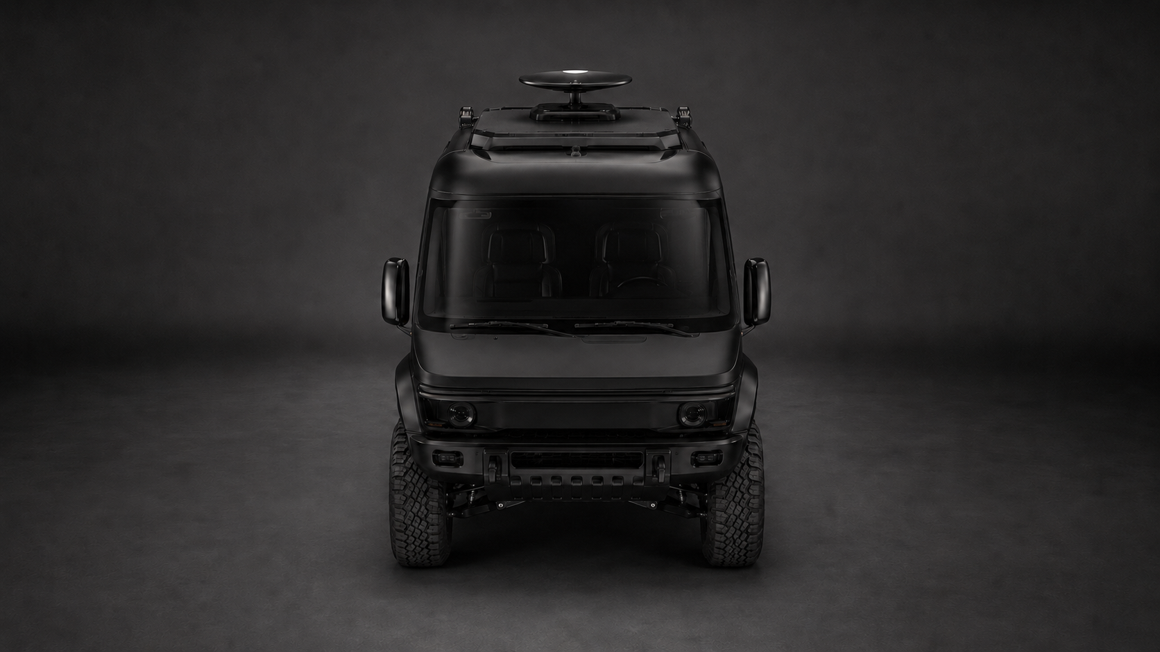 Studio front view of the WERX-Mobile concept: a matte-black high-clearance 4x4 with a roof rack and satellite dome, lit against a dark backdrop.